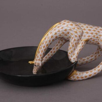 Drinking giraffe with dish